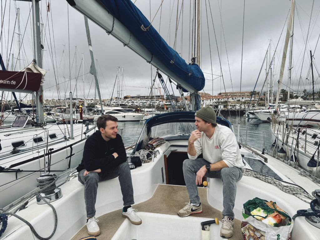 Stefan and Tristan talking on sailing boat Quetzal